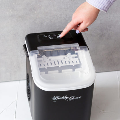 Hand pressing a button on a black ice maker with 'Healthy Choice' branding.