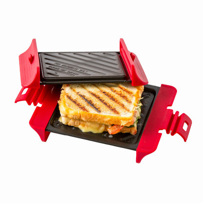 Small grill with a grilled sandwich inside on a white background