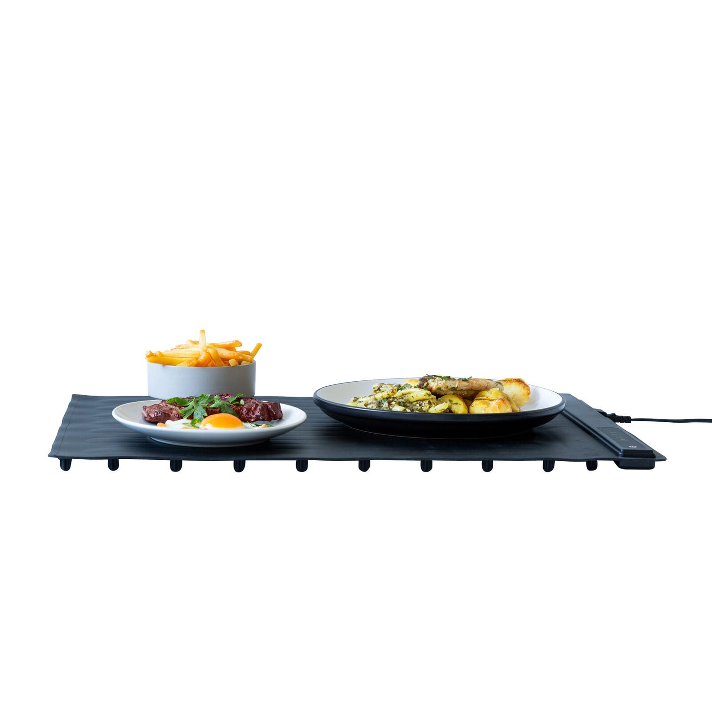 Black portable grill with plates of food on a white background