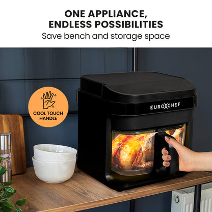 Black Eurochef appliance with a hand holding it, showing a roasted chicken inside, on a kitchen counter.