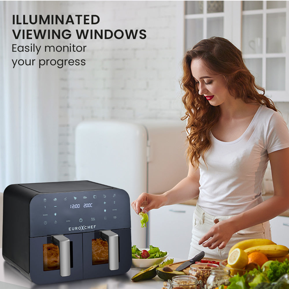 Woman preparing food in a kitchen with an air fryer, surrounded by fruits and vegetables.