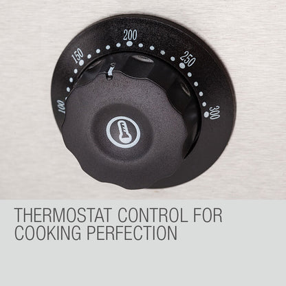Hand adjusting the Thermomate's precise 50–300°C thermostat dial for optimal cooking control.