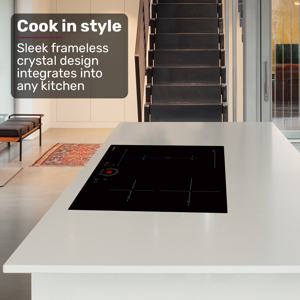 Modern kitchen with a black glass cooktop on a white countertop, featuring text about frameless crystal design.