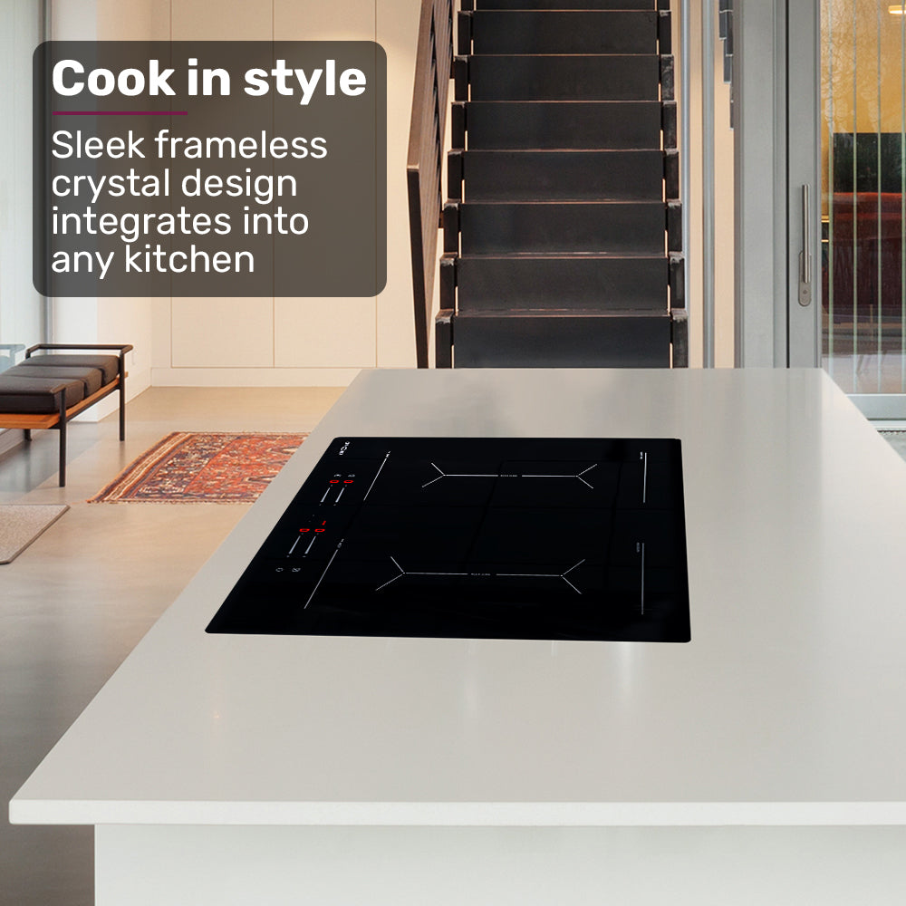 Modern kitchen with a black induction cooktop on a white countertop, featuring text about frameless crystal design.