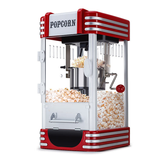 Red and white popcorn machine with popped popcorn inside, on a white background