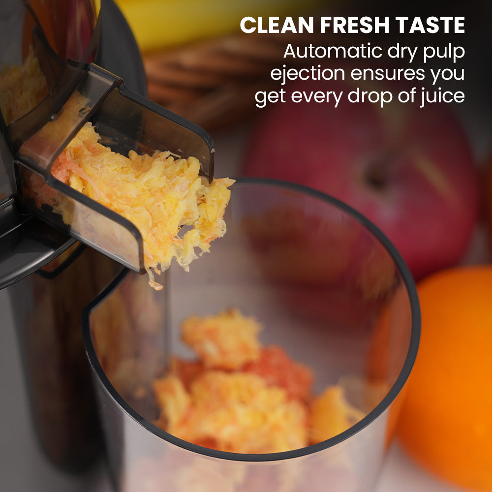 Juicer extracting juice with pulp being ejected, surrounded by fruits.