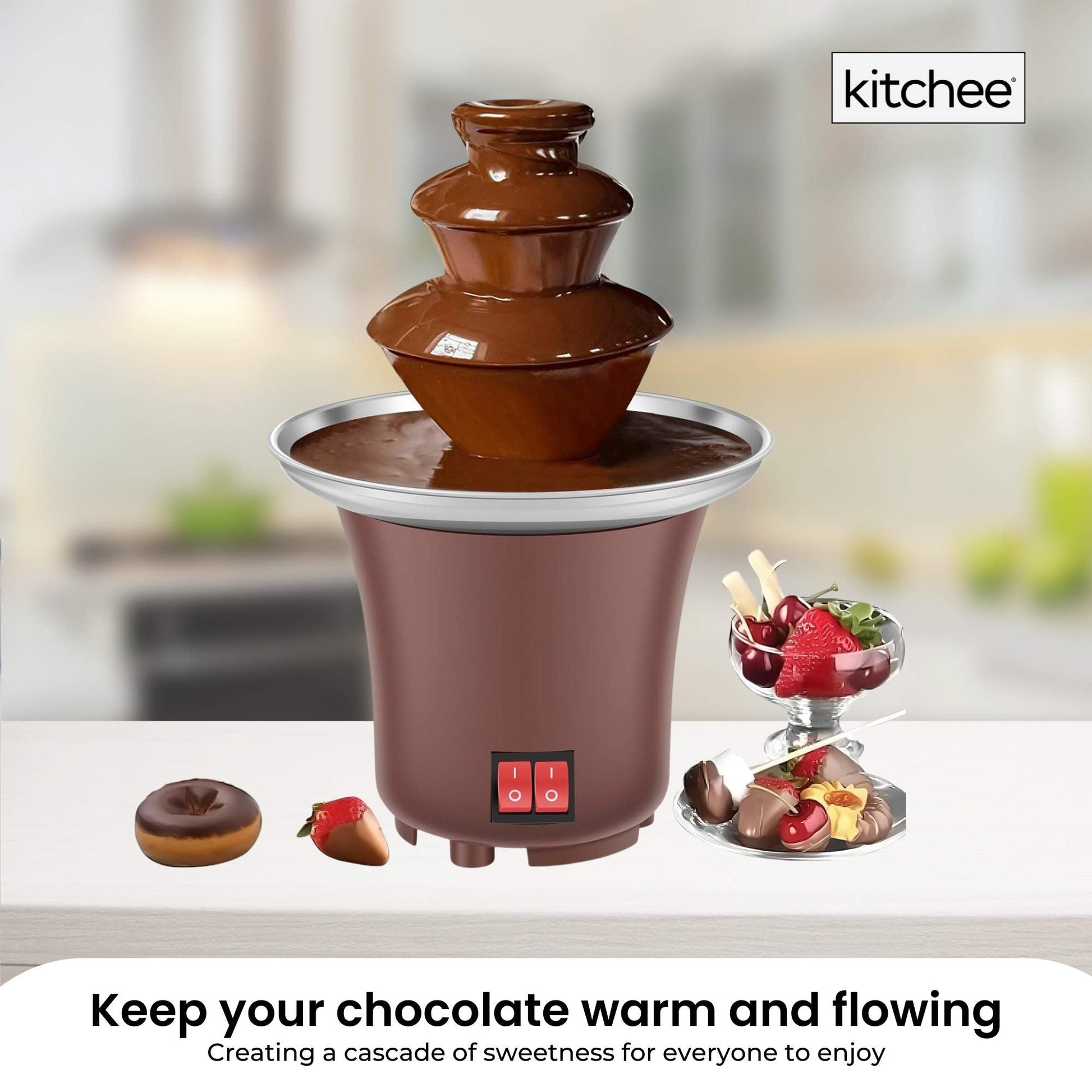 Chocolate fountain with ingredients on a blurred kitchen background, featuring the brand 'kitchee'.