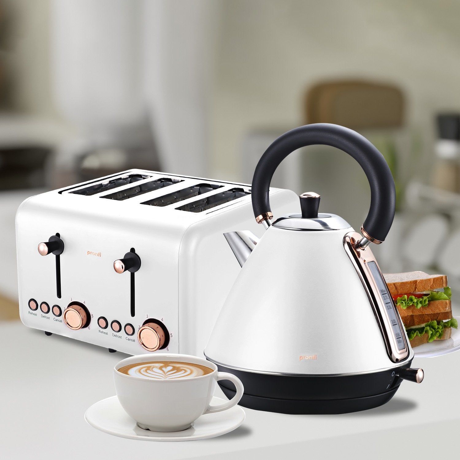White toaster and kettle with a cup of coffee on a kitchen counter.
