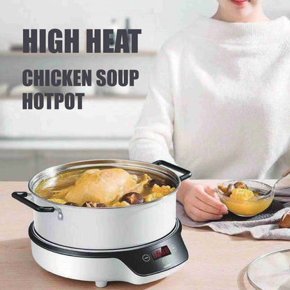 Person holding a bowl of soup next to a chicken soup hotpot on a table.