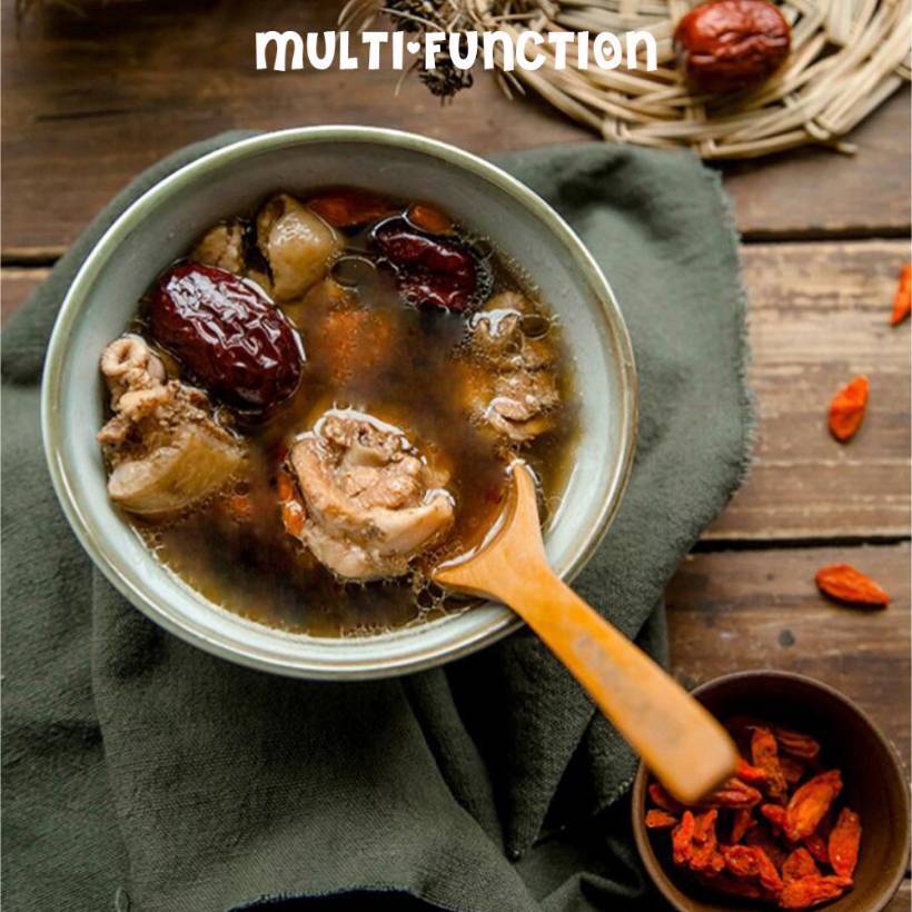 Bowl of soup with ingredients on a wooden surface, featuring the word 'MULTI-FUNCTION'.