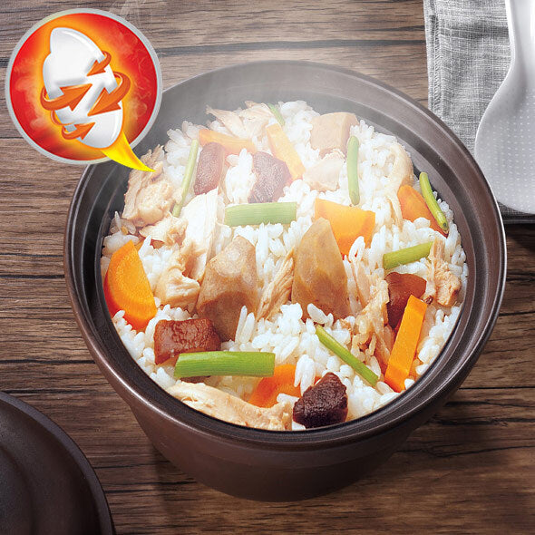 Bowl of rice with chicken and vegetables on a wooden table, featuring a hot pot logo.