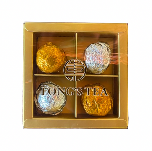 Gold box containing four tea balls with 'Long's Tea' branding on a white background