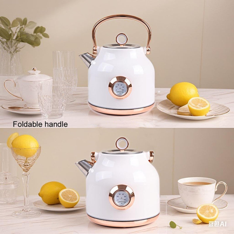 White electric kettle with rose gold accents on a kitchen counter with lemons and a cup.