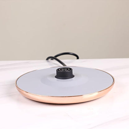 Ceramic frying pan with a black handle on a light surface