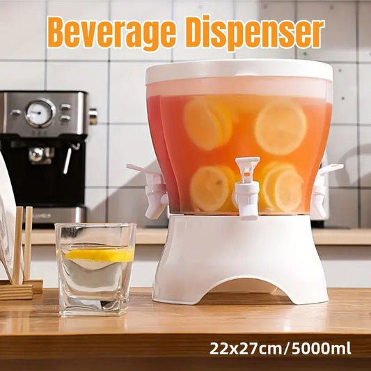 Beverage dispenser with lemon slices on a kitchen counter, next to an espresso machine.