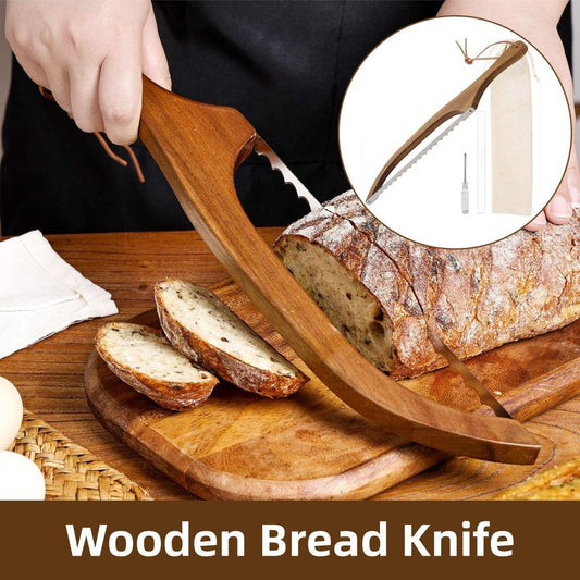 Wooden bread knife being used to cut a loaf of bread on a wooden cutting board.