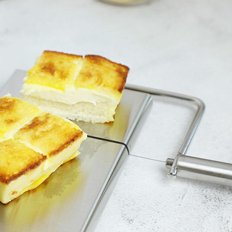 Square pieces of bread with cheese on a metal grater against a white background
