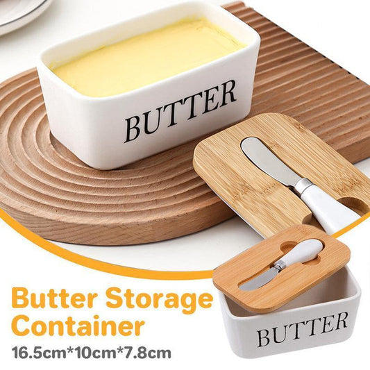Butter storage container with wooden lid and knife on a wooden surface