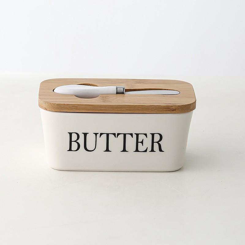 Butter container with wooden lid on a white background
