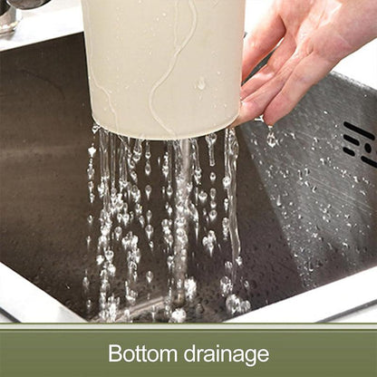 Person pouring water from a white container into a sink with bottom drainage feature.