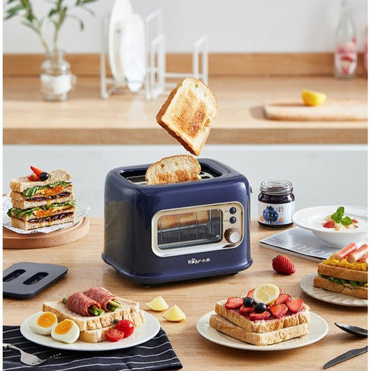 Blue toaster with slices of toast on a kitchen counter with various breakfast items.