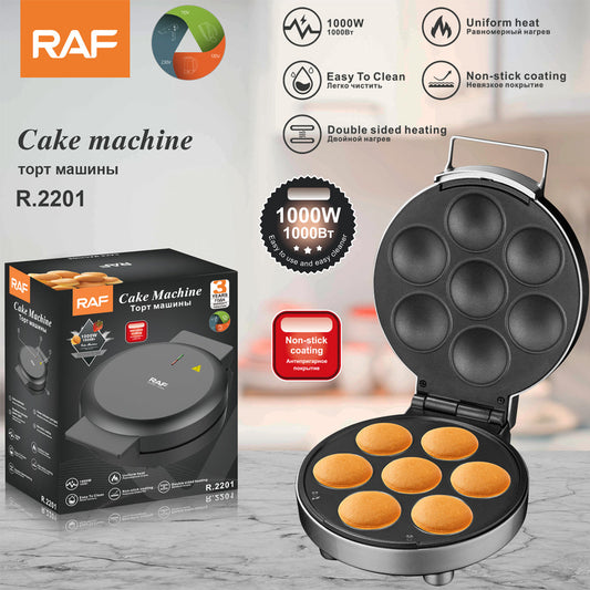 RAF cake machine with open lid showing baked cakes, packaging, and feature icons on a blurred background.