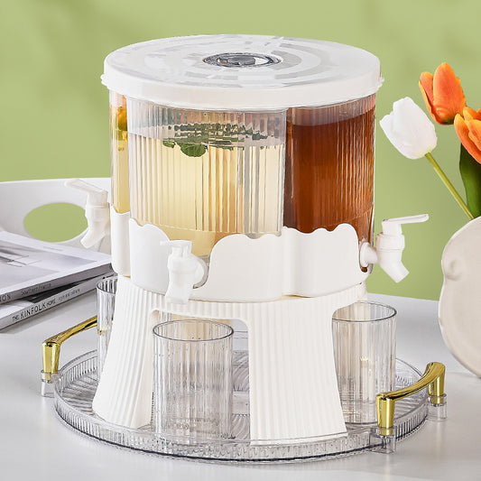 Tea infuser with clear container on a decorative tray with a green background