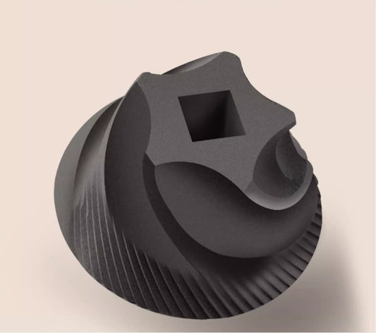 Black plastic component with square hole on beige background