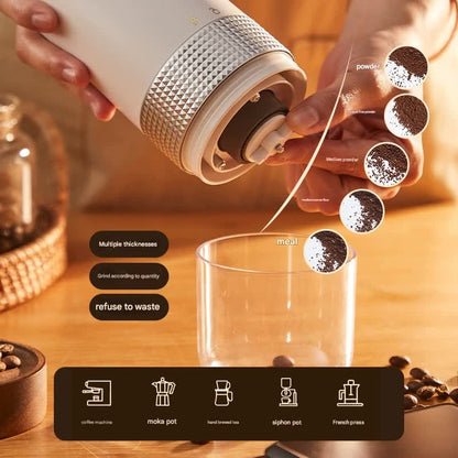 Person using a manual coffee grinder to grind coffee beans into a glass mug on a wooden surface.