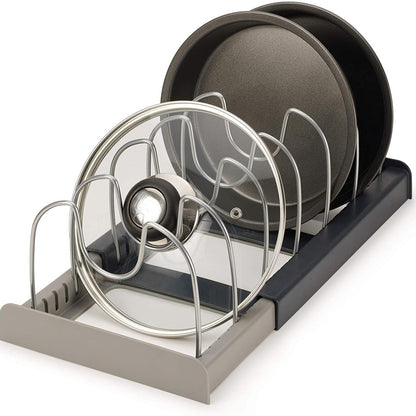 Dish rack with plates and lids on a white background
