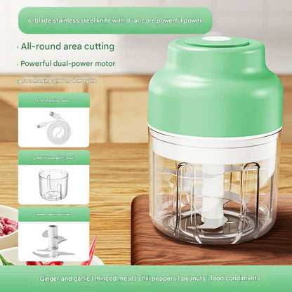 Green and white electric food chopper on a wooden surface with text highlighting features.