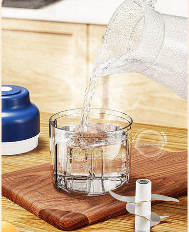 Clear glass being filled with water on a wooden cutting board with a neutral background
