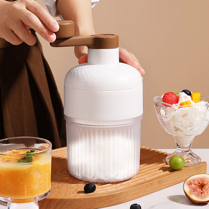 White kitchen appliance on a wooden tray with a dessert and drink in the background