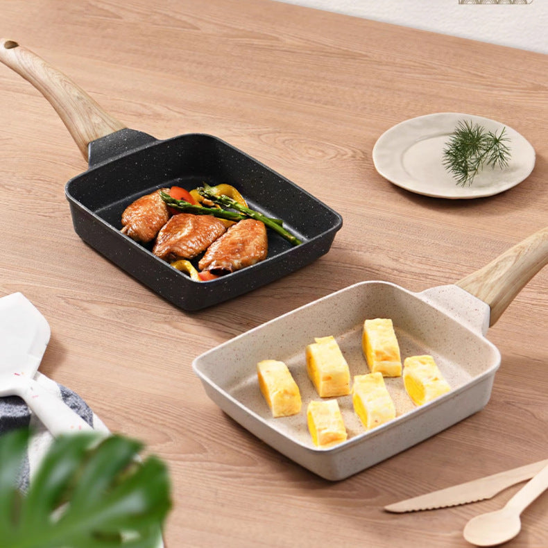 Two ceramic cookware items on a wooden surface with food inside.