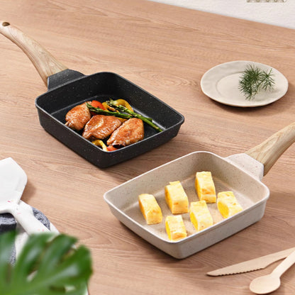 Two ceramic cookware items on a wooden surface with food inside.