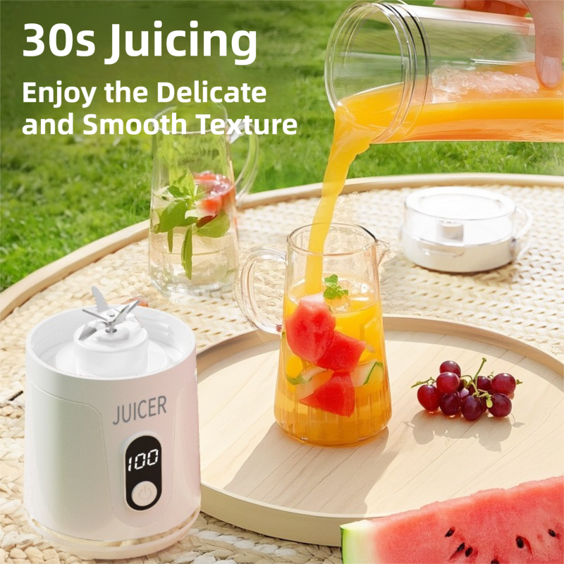 Juicer with a glass of juice and fruits on a table outdoors