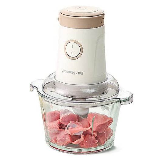 Hand blender with a clear container holding pink ingredients on a white background