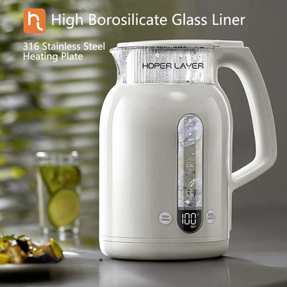 White electric kettle with digital display on a kitchen counter, featuring high borosilicate glass liner and 316 stainless steel heating plate.