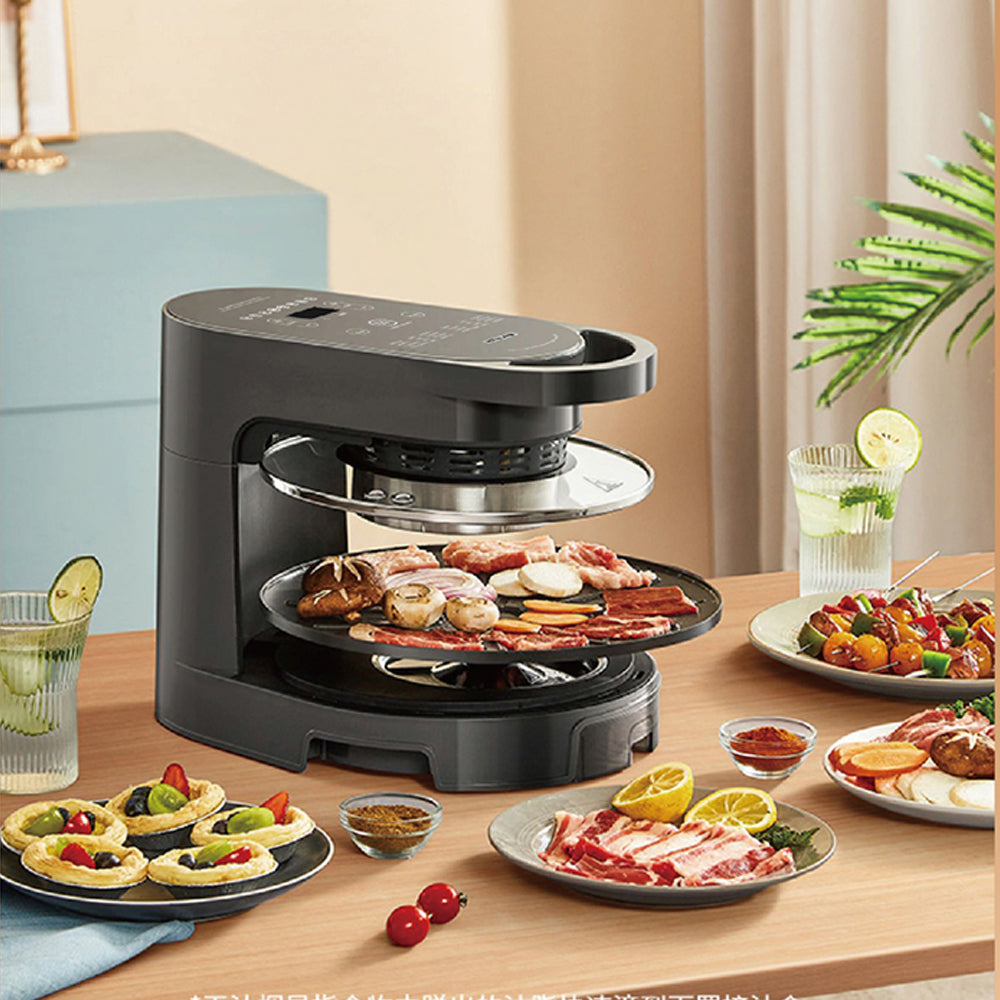 Black indoor grill on a wooden table with food and drinks in a kitchen setting
