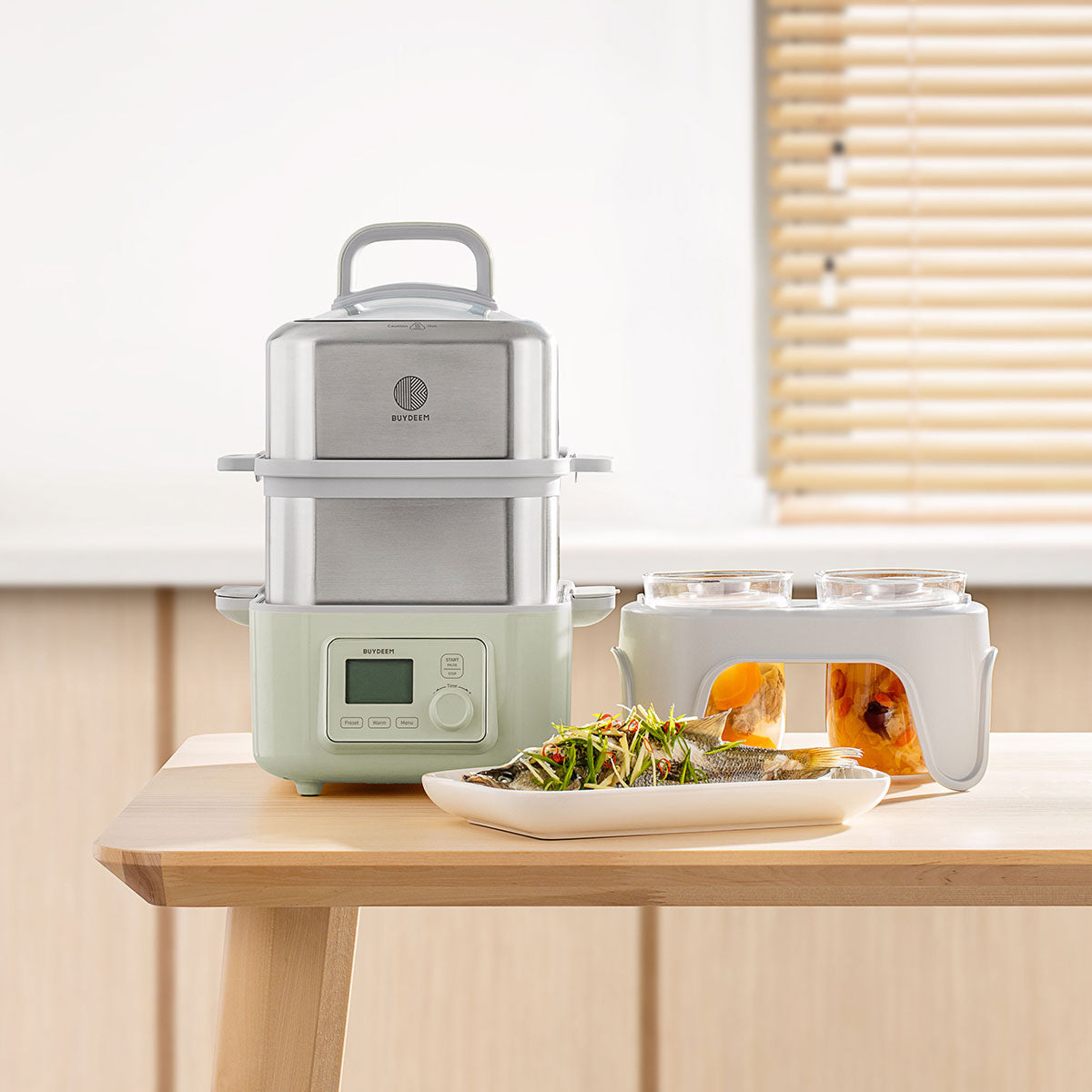 Green kitchen appliance on a wooden table with a plate of food in front of it.