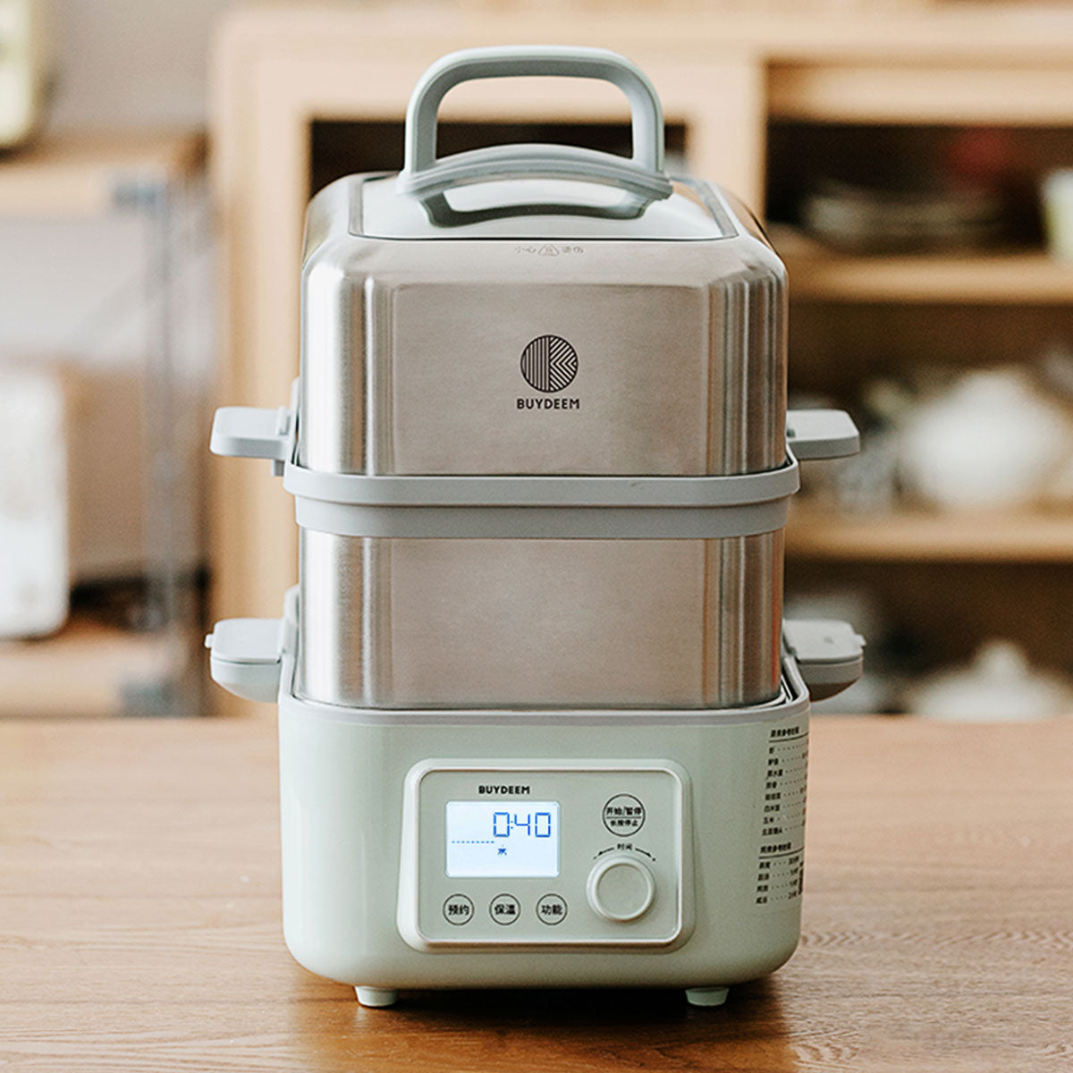 Stainless steel kitchen appliance with digital display on a wooden surface