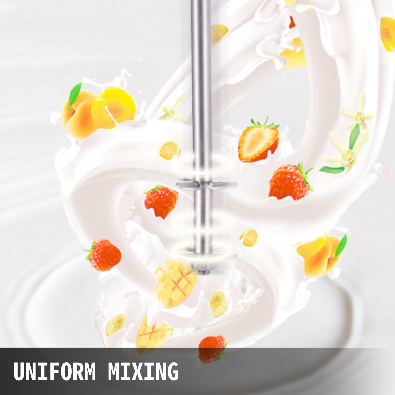 Hand mixer in action with whipped cream and fruit decorations on a white background