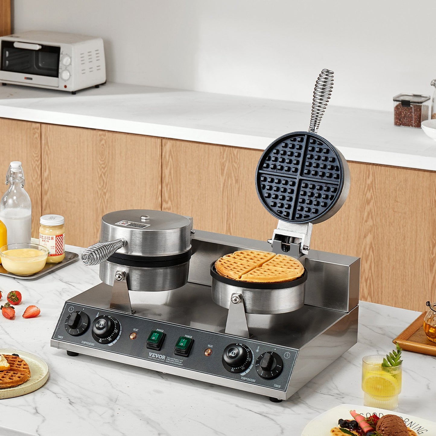 Waffle maker on a kitchen counter with waffles and ingredients