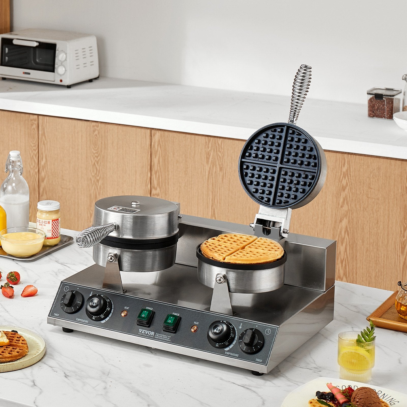 Waffle maker on a kitchen counter with waffles and ingredients