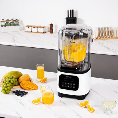 Blender with a yellow liquid on a kitchen counter with fruits and juice.