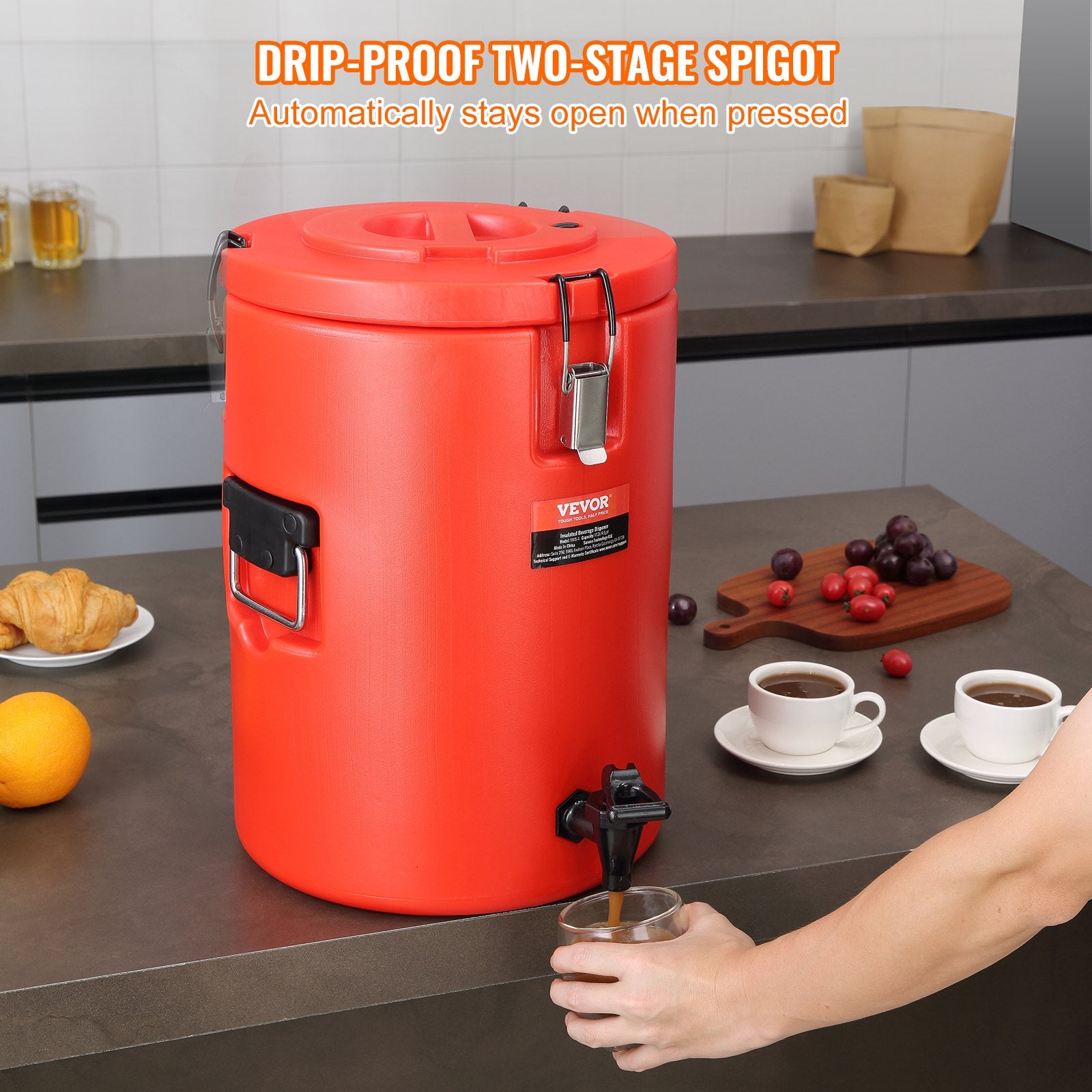 Red coffee urn with drip-proof two-stage spigot on a kitchen counter.