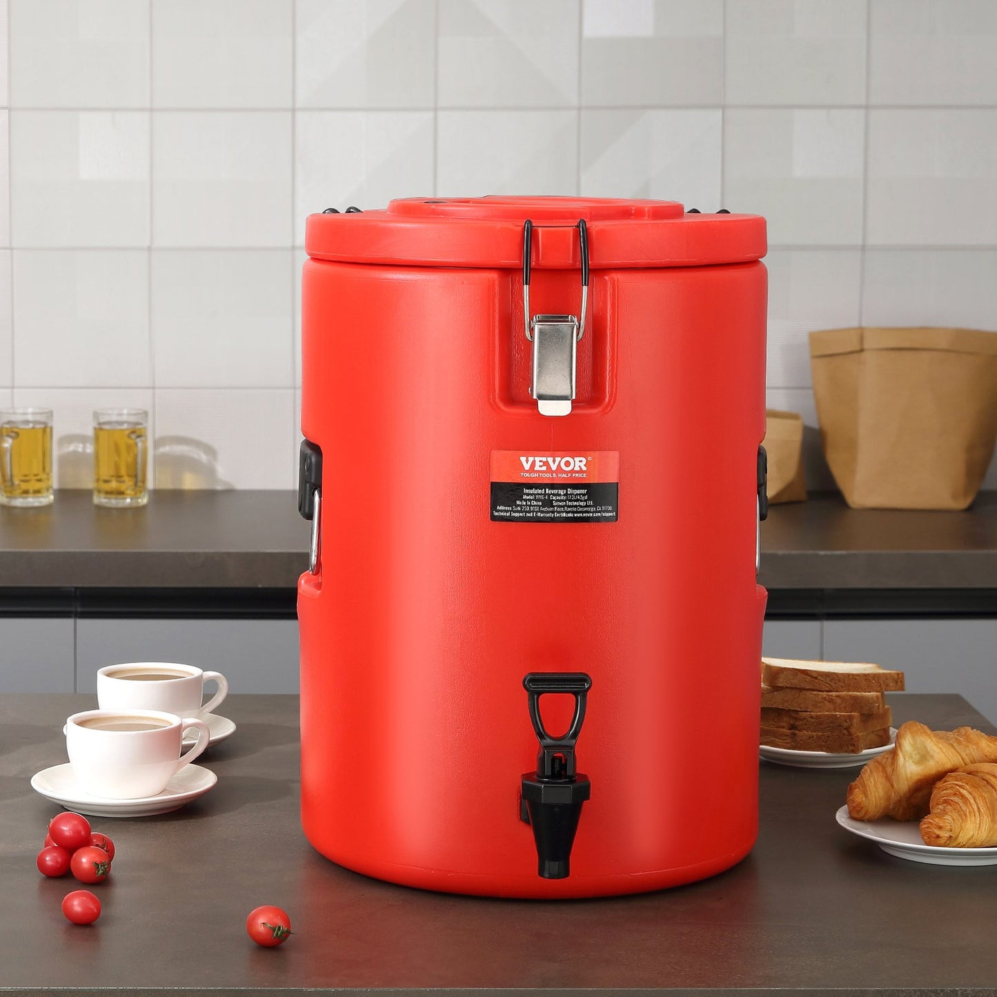 Red Vevor coffee urn on a kitchen counter with coffee cups and food items.