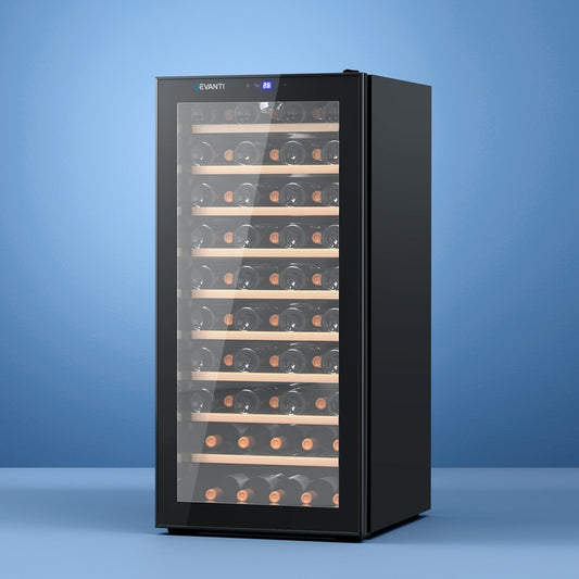 Black wine cooler with glass door displaying wine bottles on a blue background