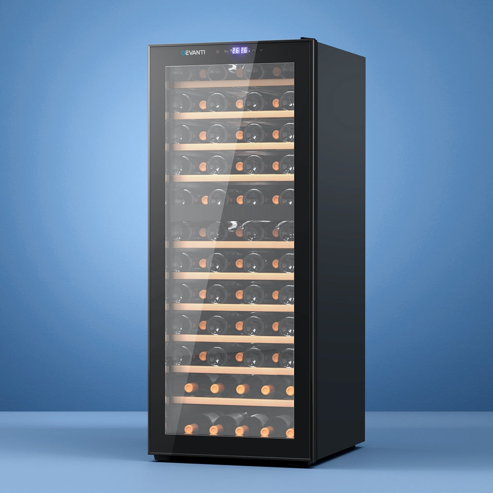 Black wine cooler with glass door displaying wine bottles on a blue background