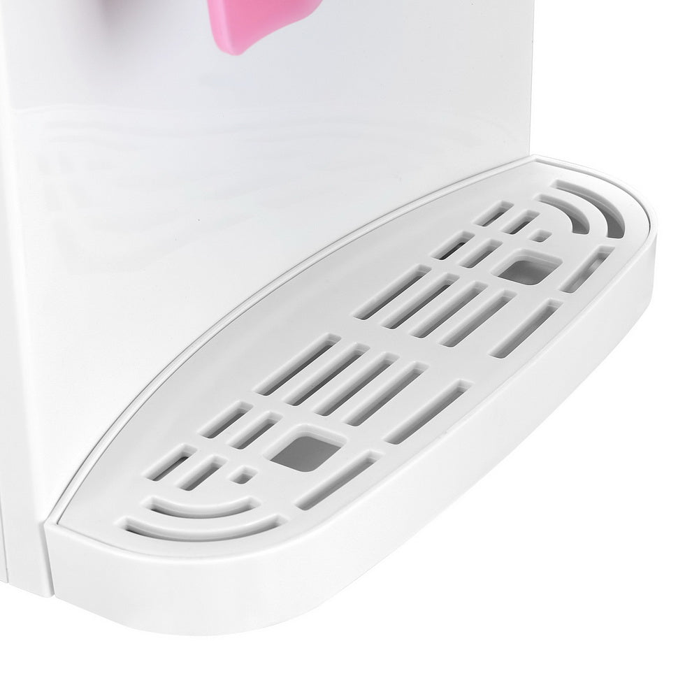 White iron with a pink handle on a white background